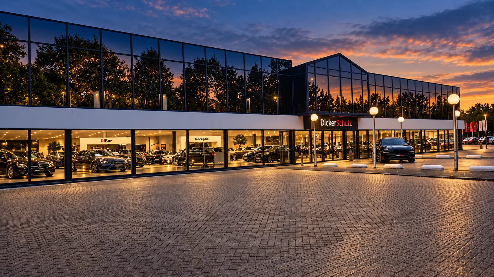 Verlichte showroom van DickerSchutz in Maastricht bij zonsondergang
